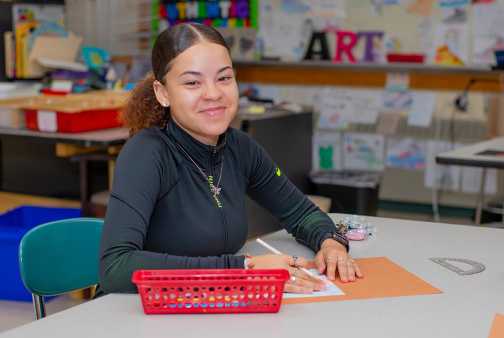 BEST Smiling Female Student with Pencil In Hand