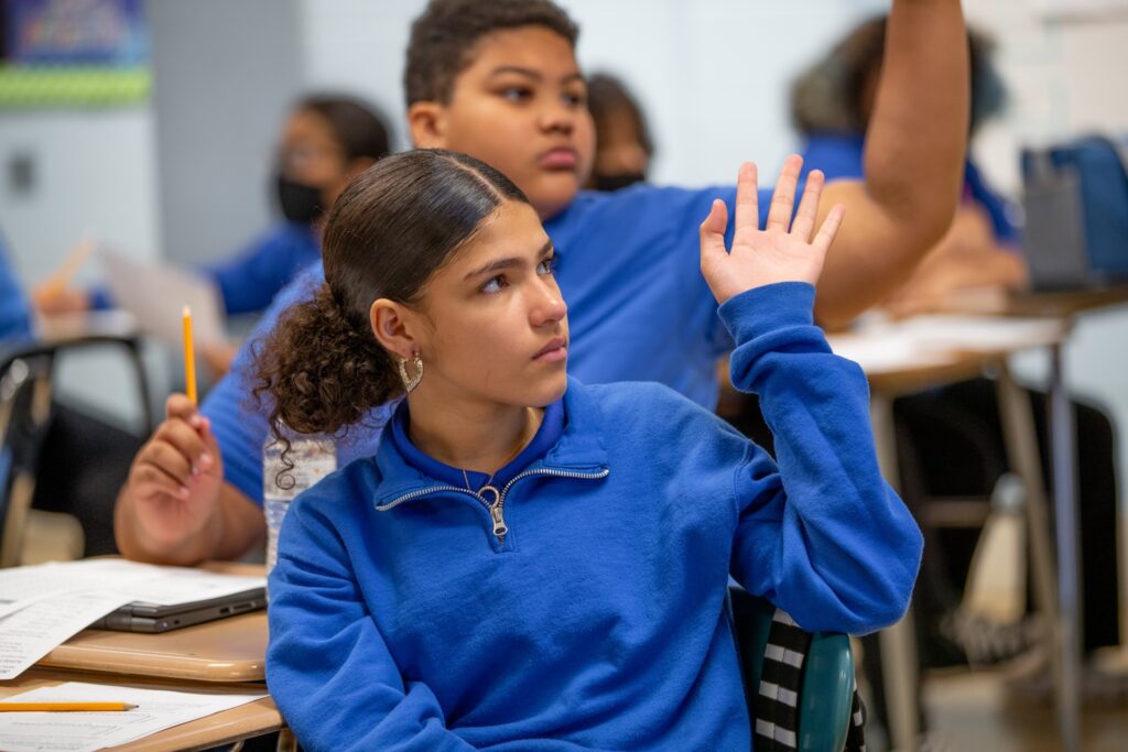 Girl Raising Hand In Class at TAG